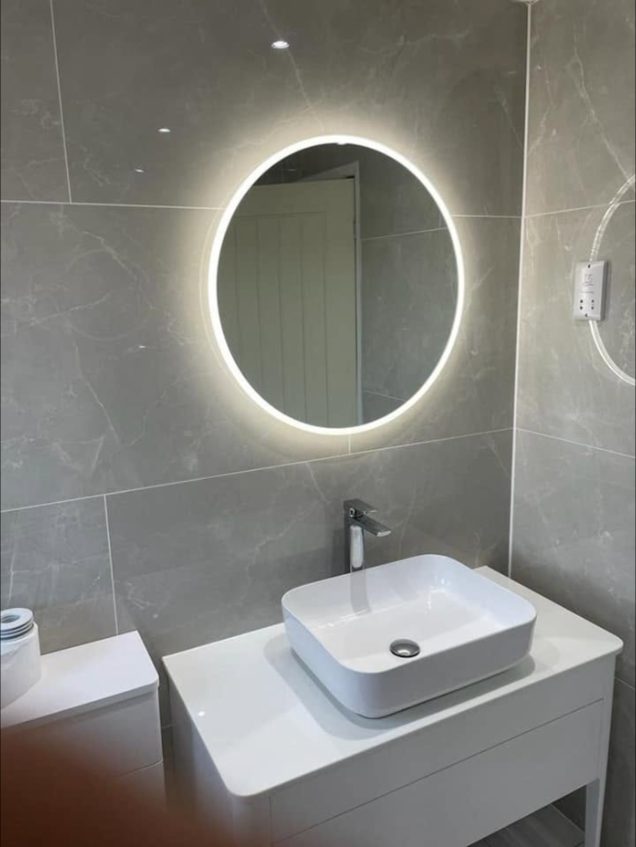 Bathroom with LED mirror and countertop basin