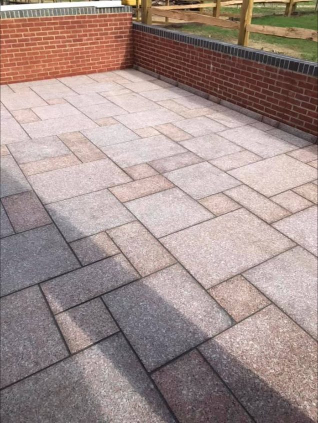 Granite patio with brick wall