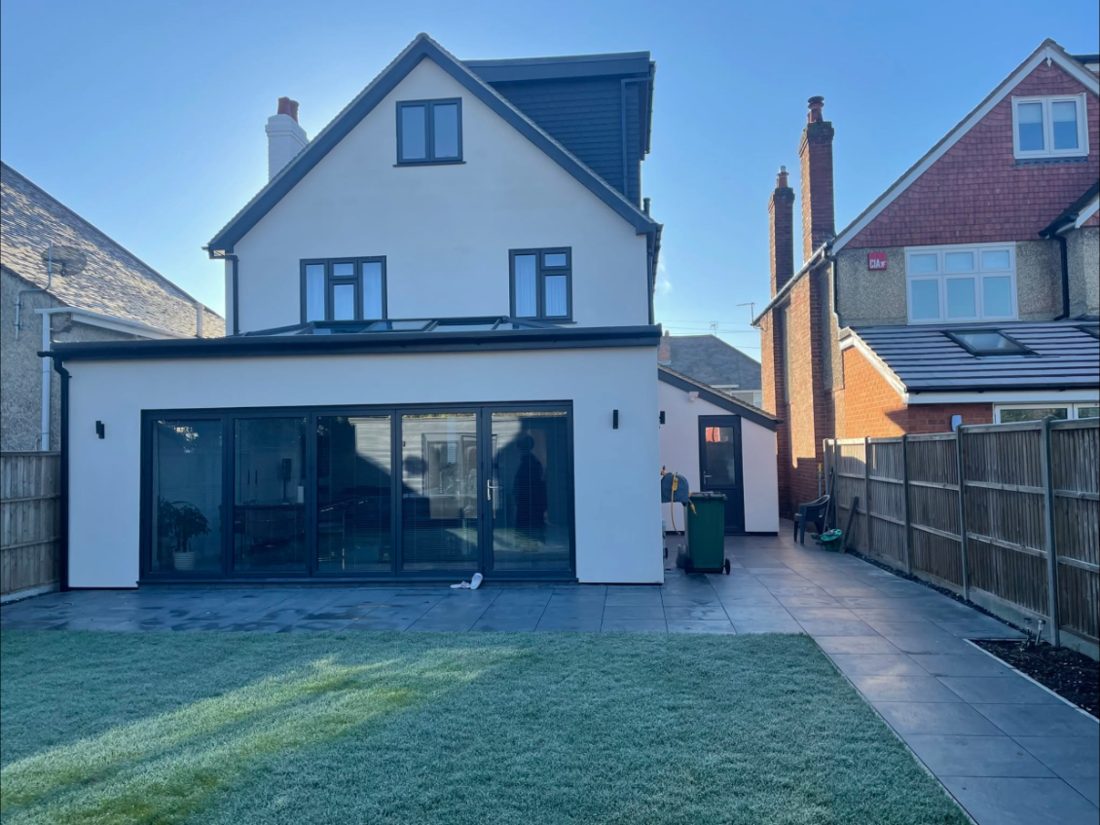 Rear extension with bi-fold doors and new patio, built by Whites